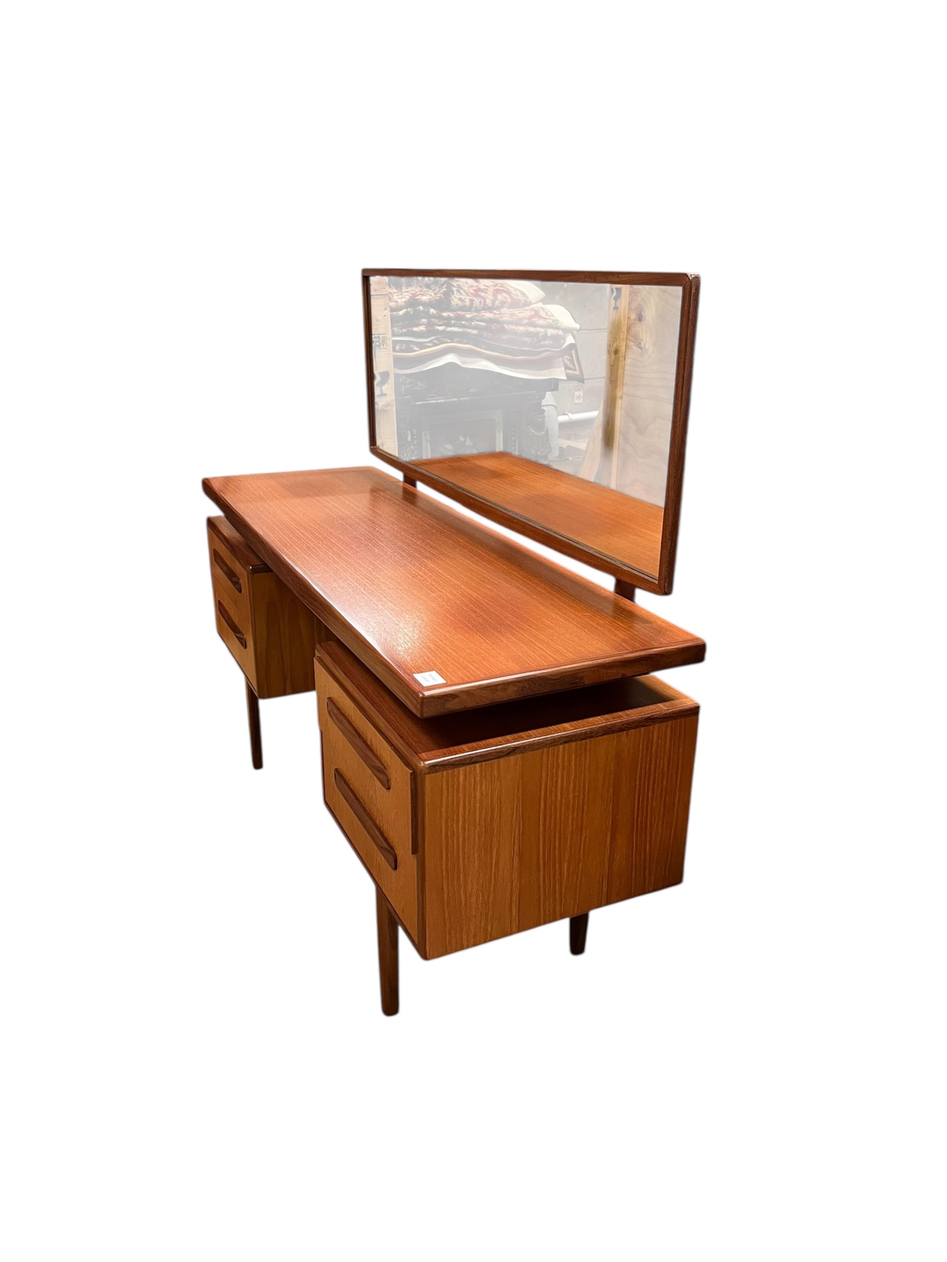 A mid century G Plan Fresco teak bedroom suite comprising a three door wardrobe, a two door wardrobe, two six drawer chests, dressing table, headboard and a pair of bedside chests